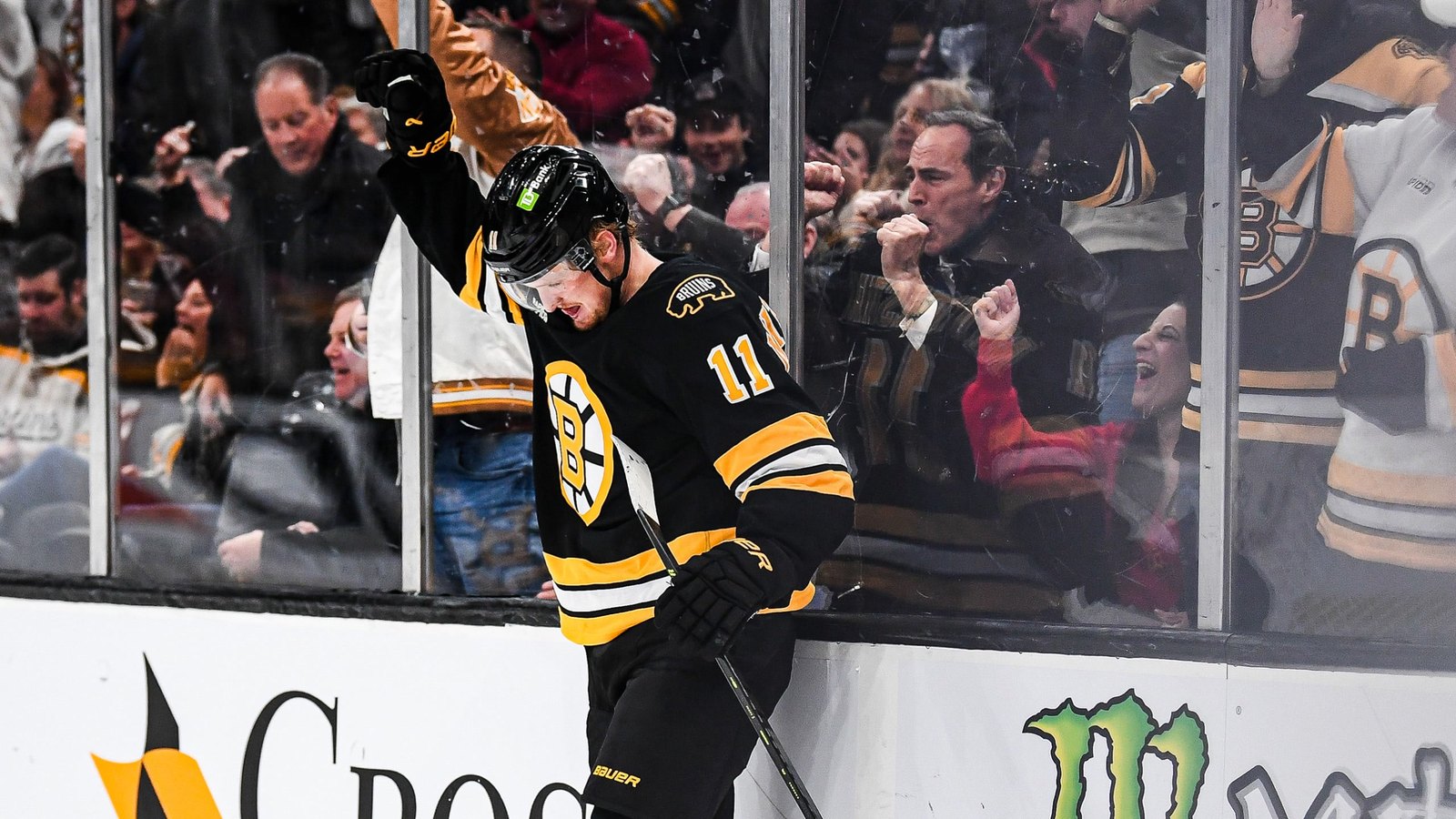 Casey Mittelstadt celebrates against the glass with teammates