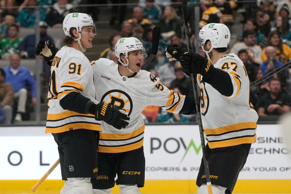 Matt Poitras celebrates a goal with Nikita Zadorov and Mark Kastelic